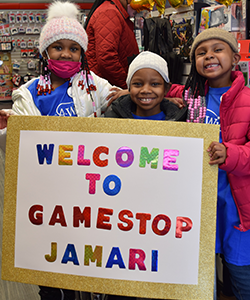 Wish child Jamarri and sisters smiling at GameStop